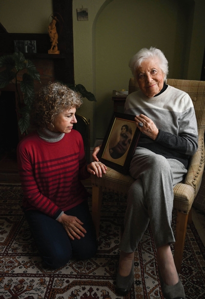Rosl was born in Vienna in 1926. She is pictured with her daughter Lesley. Rosl is holding a photographic portrait of her mother-in-law Ida who was killed in Auschwitz. Marc, Rosl’s husband, escaped to England on a Kindertransport. Rosl went on to have 2 children and 6 grandchildren. - © Carolyn Mendelsohn